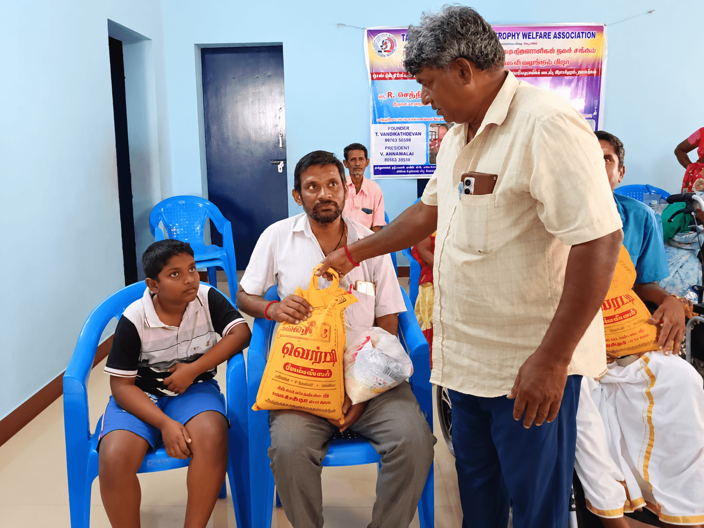 A TNMDA volunteer handing provisions to a member