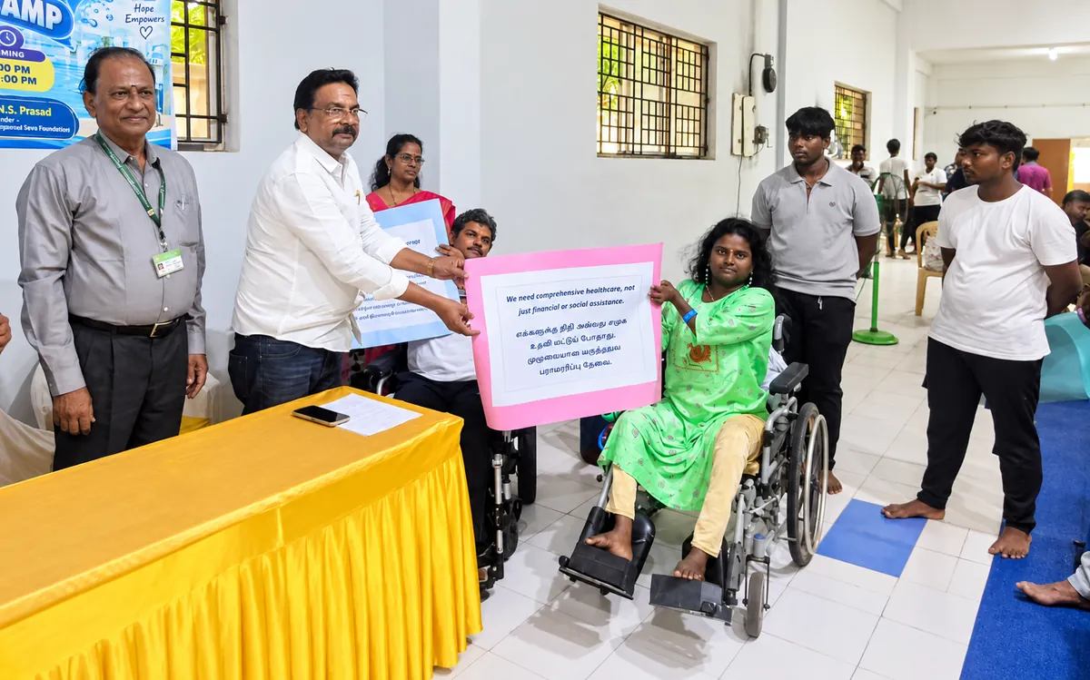 Members holding awareness placards at the hydrotherapy camp