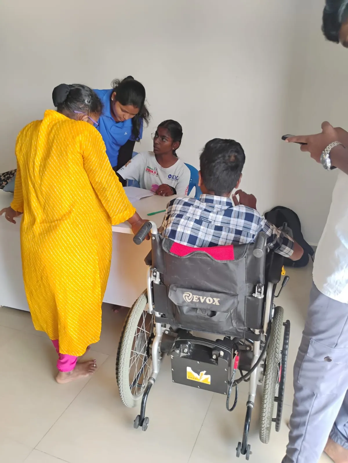 Members registering at the desk during the hydrotherapy camp