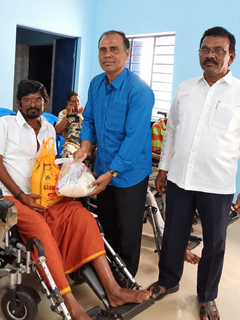 A TNMDA volunteer distributing supplies to a family member